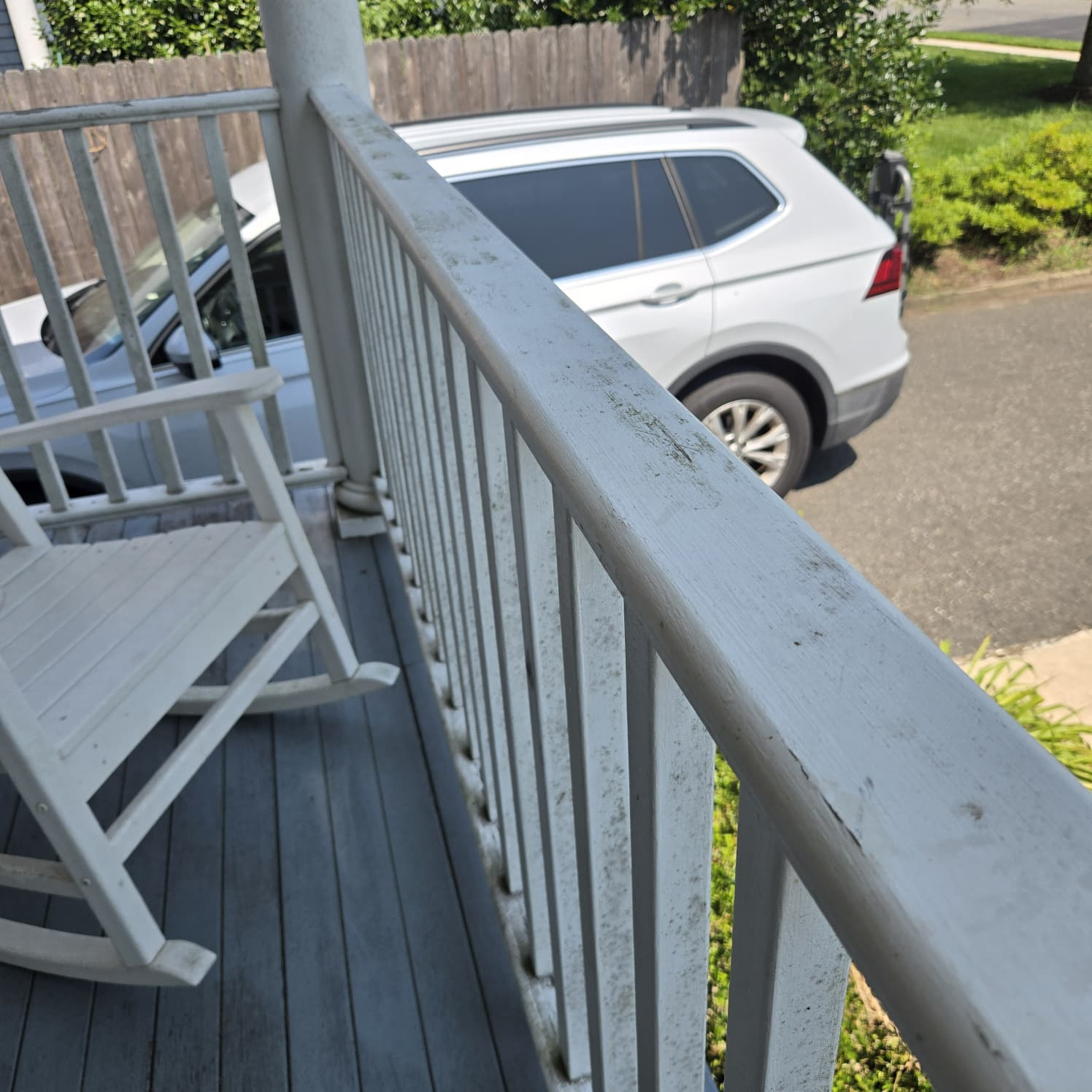 Dirty porch railing before power washing