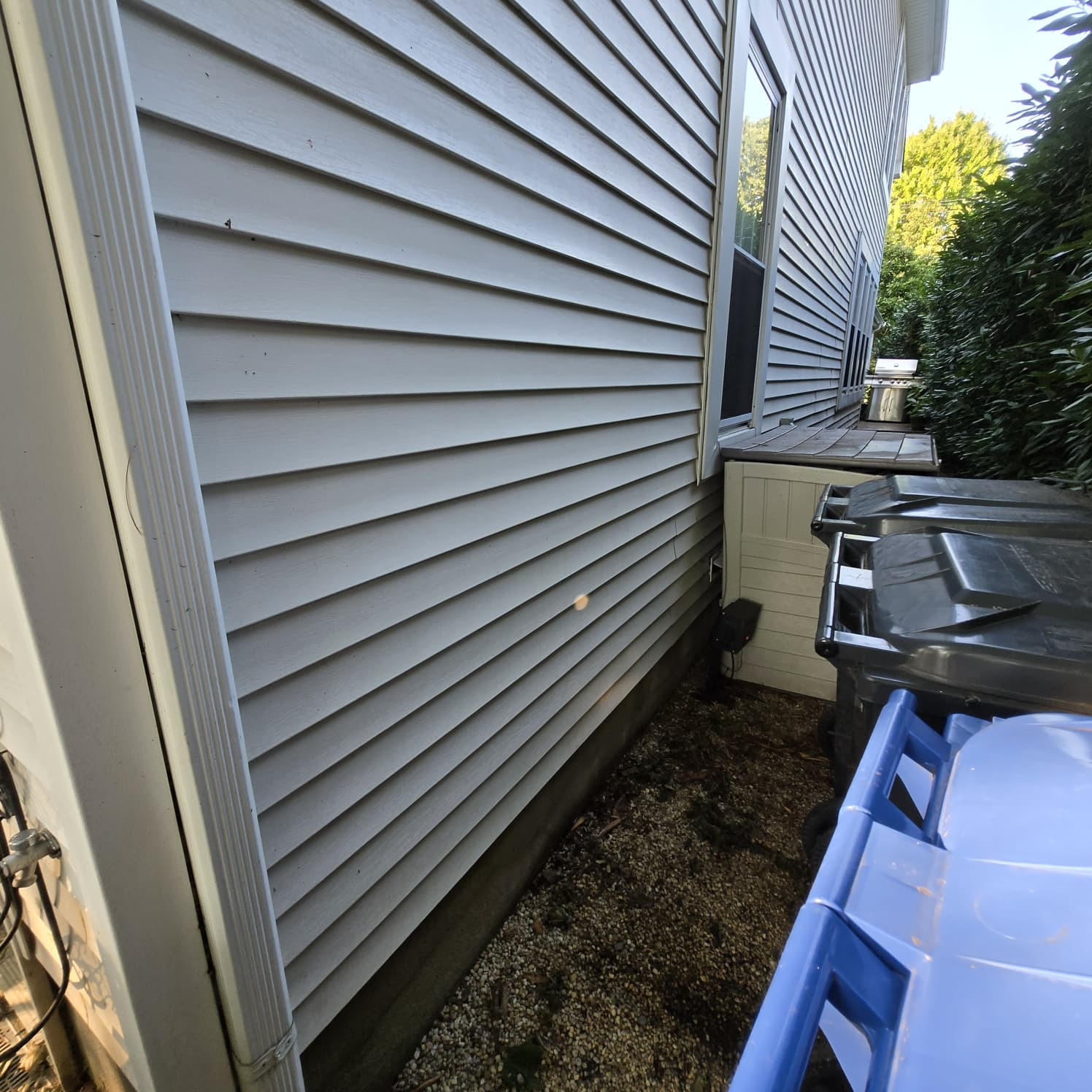 Clean house siding after power washing