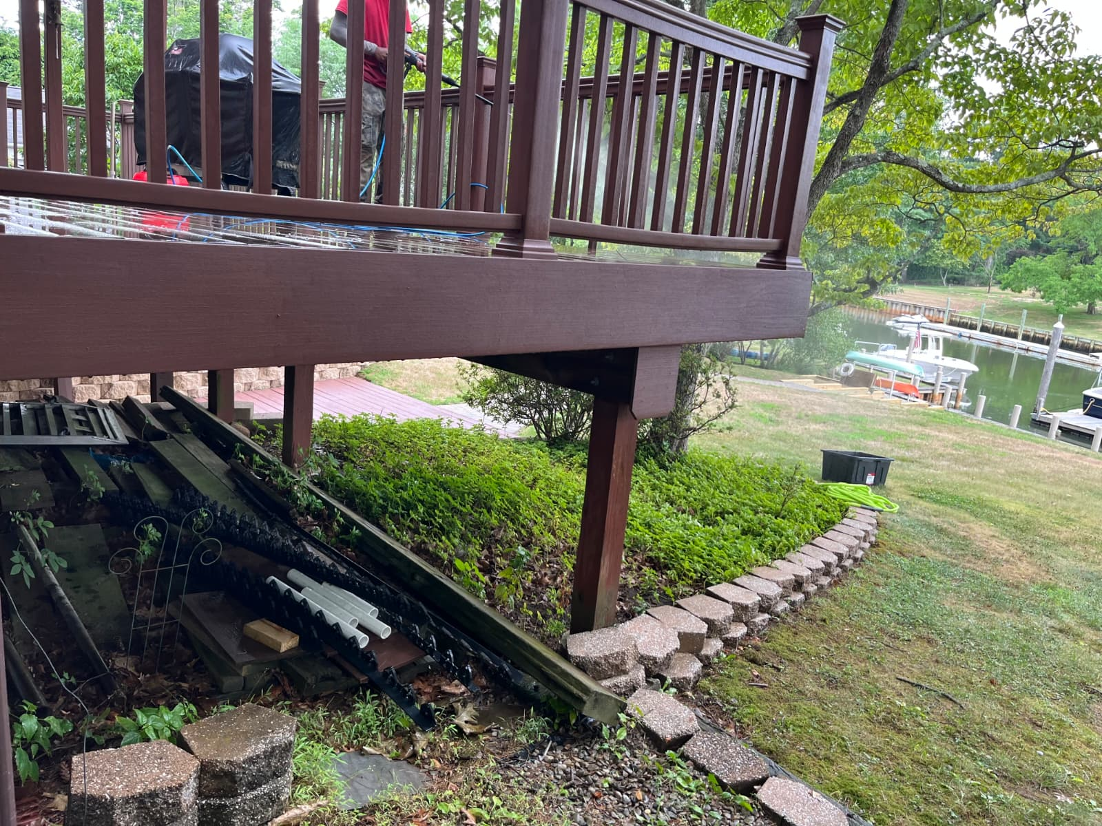 Technician power washing deck railing