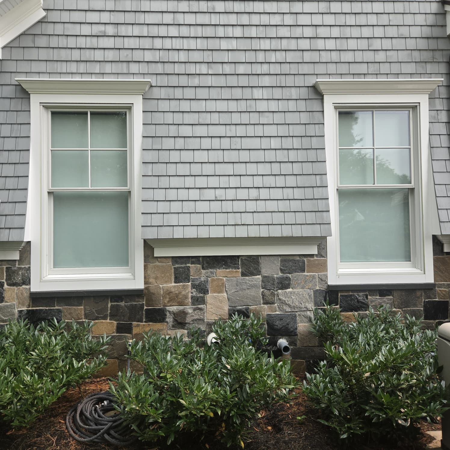 House washing result on stone and shingle siding
