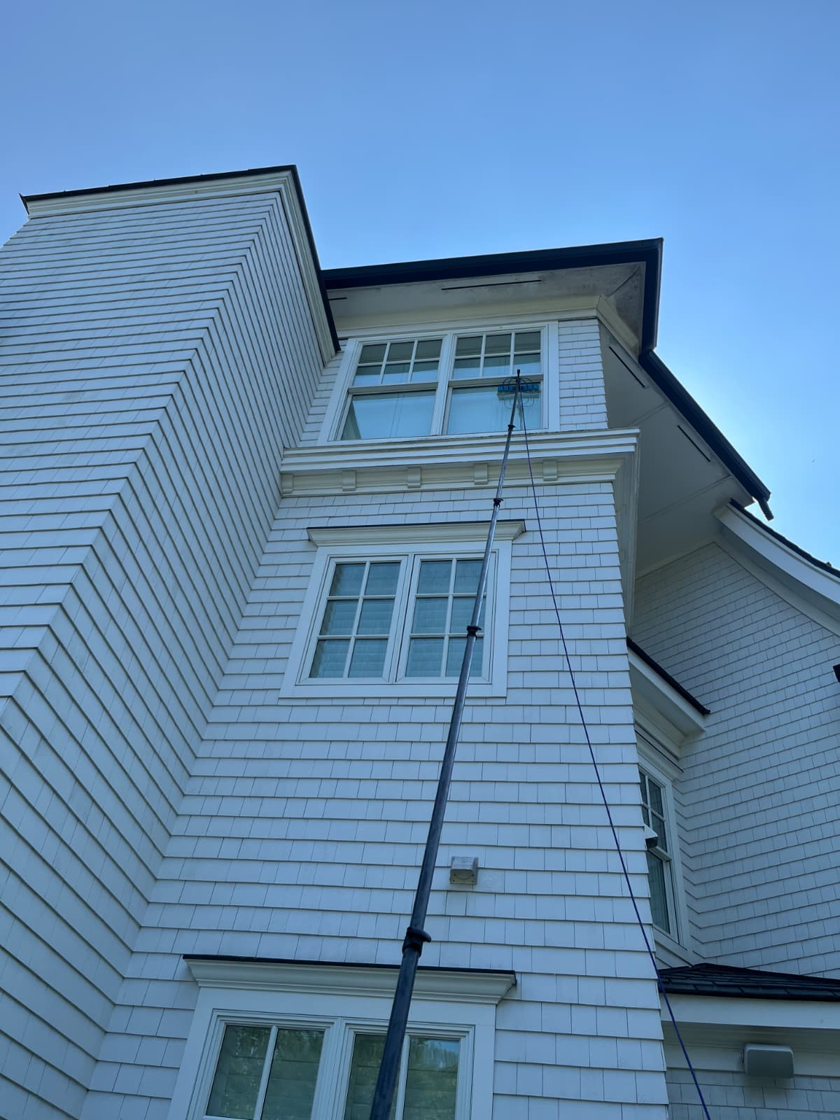 Window cleaning on upper floor with extension pole
